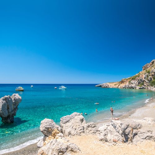 There is a palm forest and a river inside the gorge near this beach.